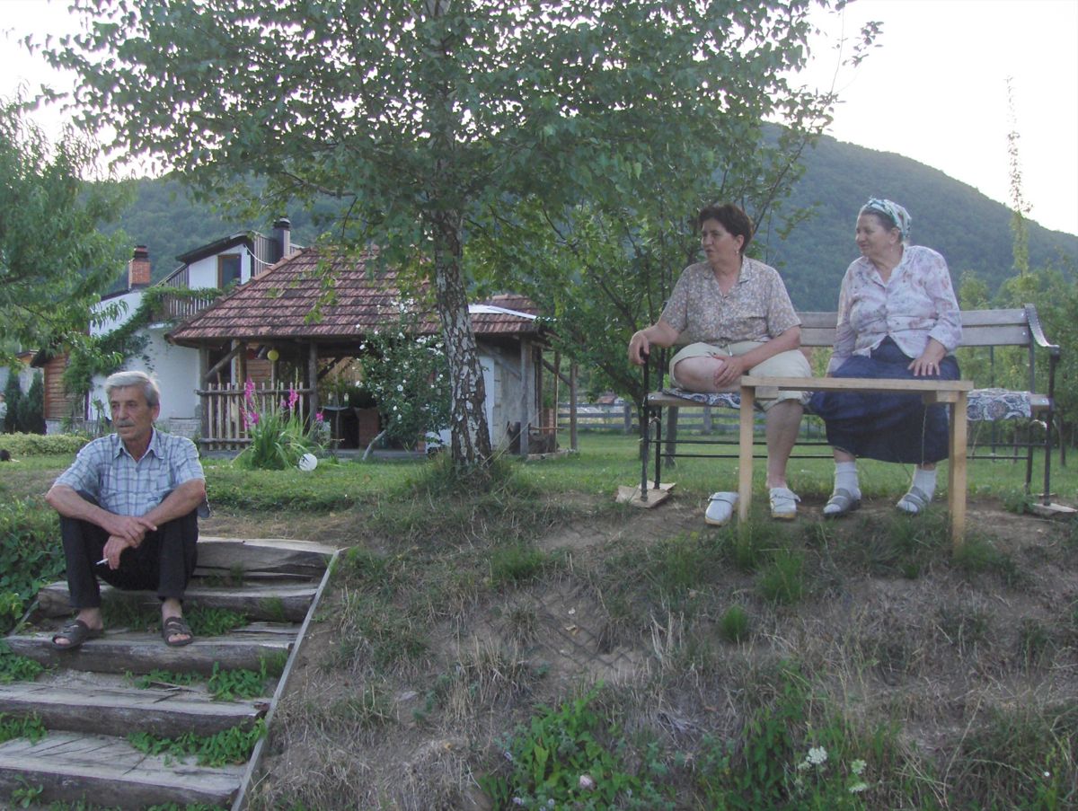 Family sitting together on the garden steps and bench